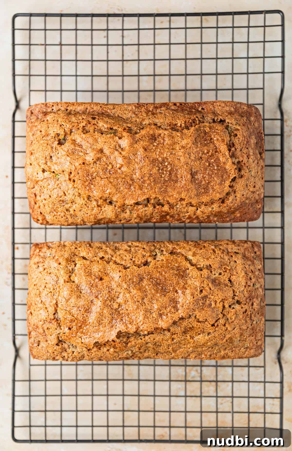 Grandma’s Zucchini Bread Recipe (Even Better) 14 Two loaves of grandma's zucchini bread cooling on wire rack.