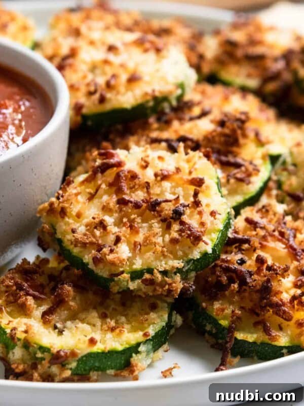 Grandma’s Zucchini Bread Recipe (Even Better) 17 Zucchini with crispy cheese coating on plate.