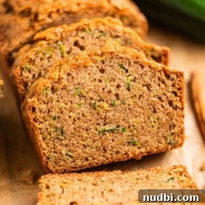 Grandma’s Zucchini Bread Recipe (Even Better) 20 Slices of zucchini bread propped on each other on parchment paper.
