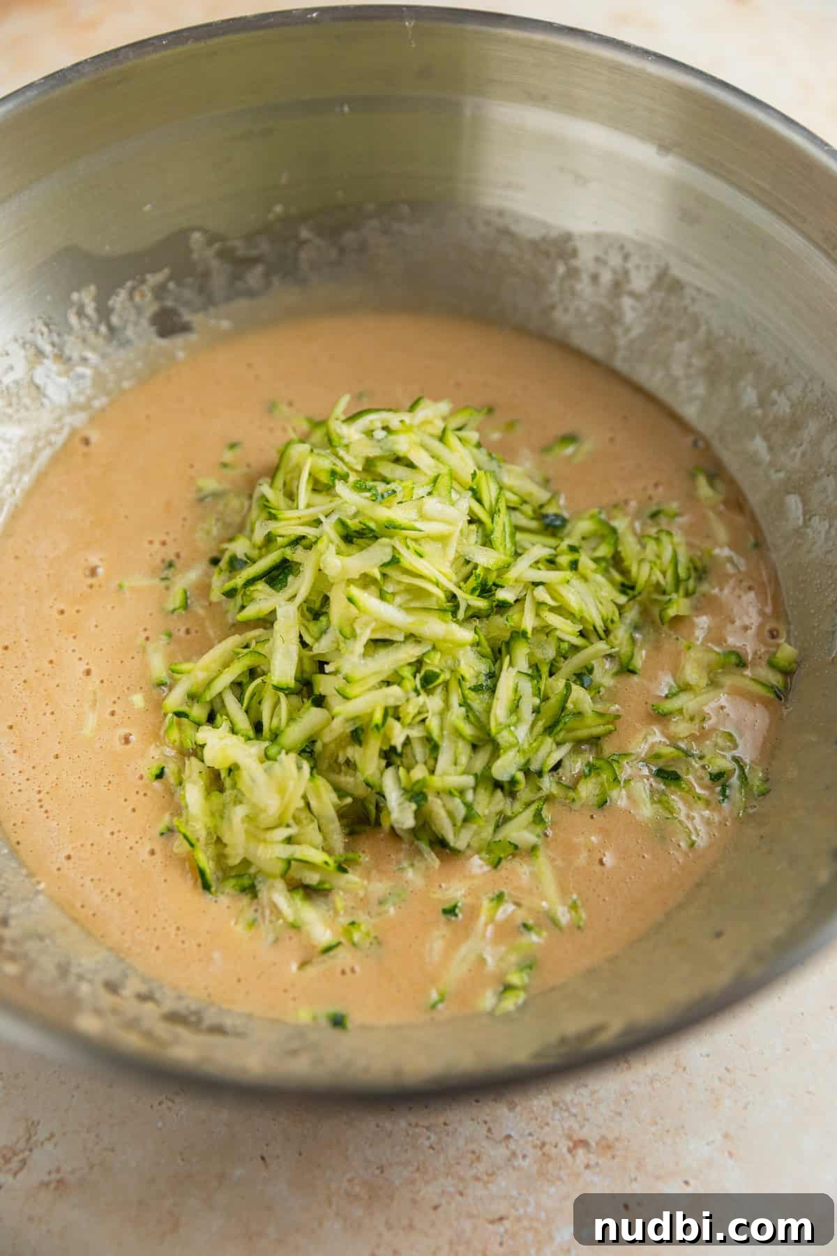 Grandma’s Zucchini Bread Recipe (Even Better) 7 Shredded zucchini added to zucchini bread batter mixture.