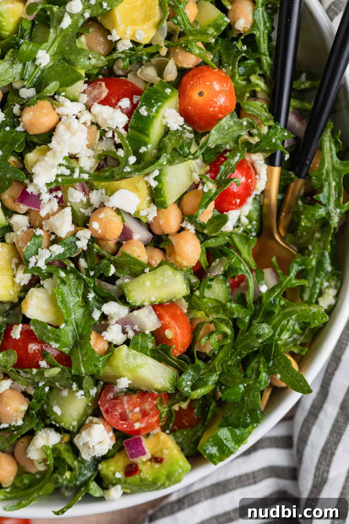 Creamy Chickpea and Avocado Salad with Lemon Dressing 8 Fork and spoon in bowl with arugula salad.
