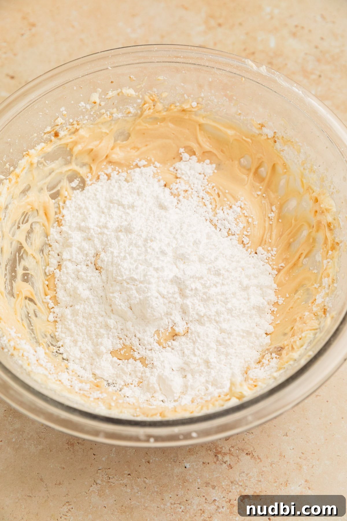 Pumpkin Bread Made from Cake Mix: Quick Moist Recipe 13 Powdered sugar added to cream cheese frosting mixture in bowl.
