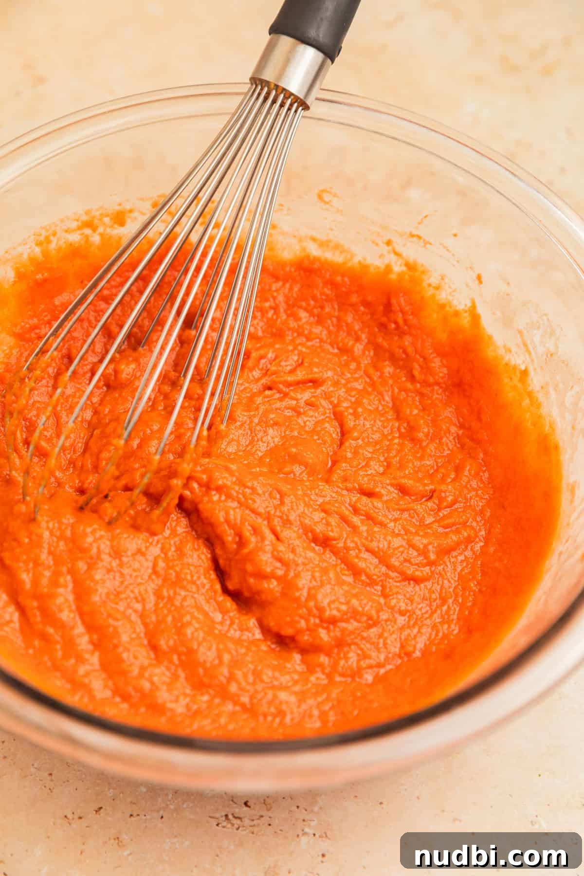 Pumpkin Bread Made from Cake Mix: Quick Moist Recipe 7 Pumpkin mixture in glass bowl with whisk.