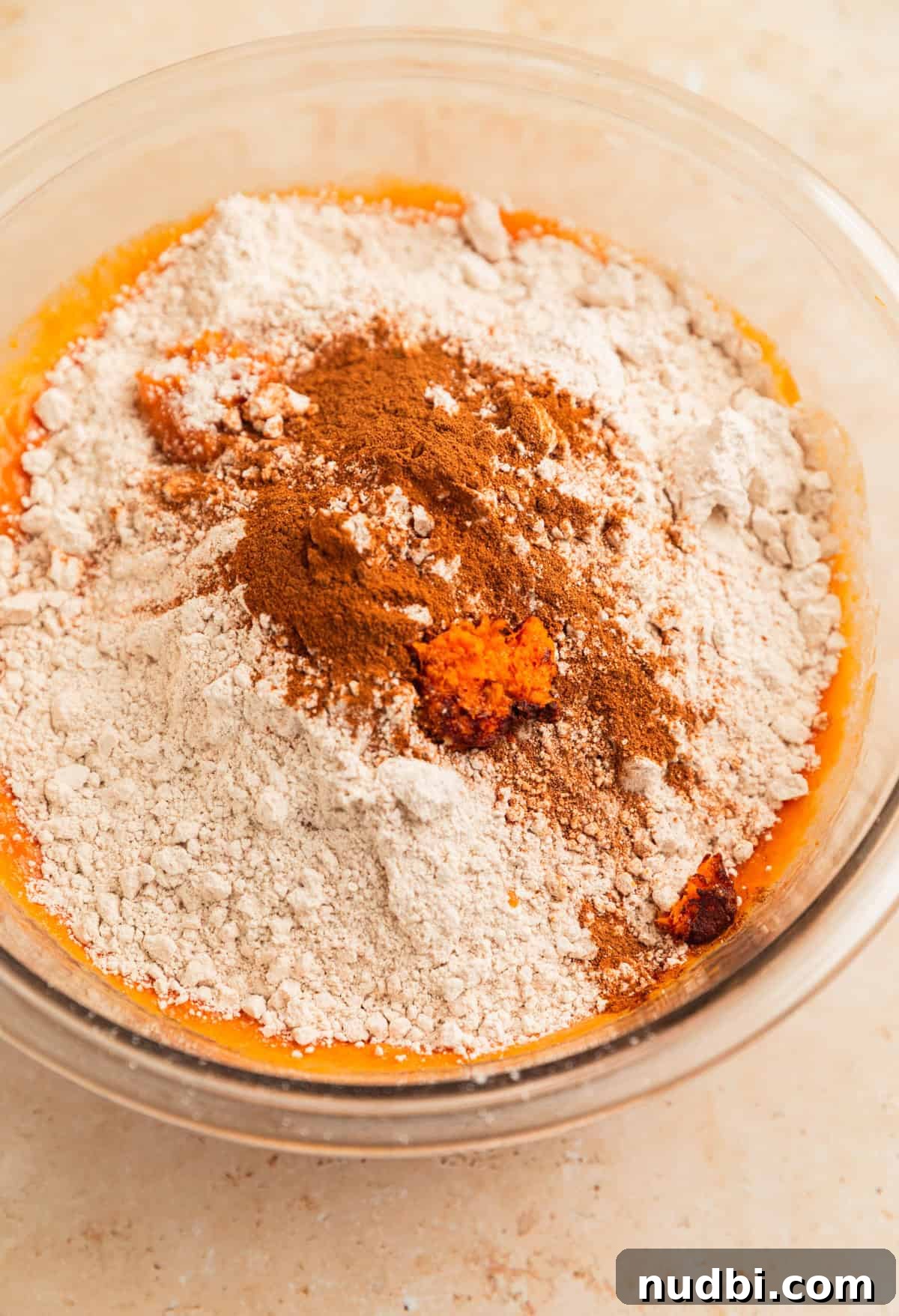 Pumpkin Bread Made from Cake Mix: Quick Moist Recipe 8 Spice cake mix, pumpkin spice and orange zest added to pumpkin bread wet ingredients in bowl.