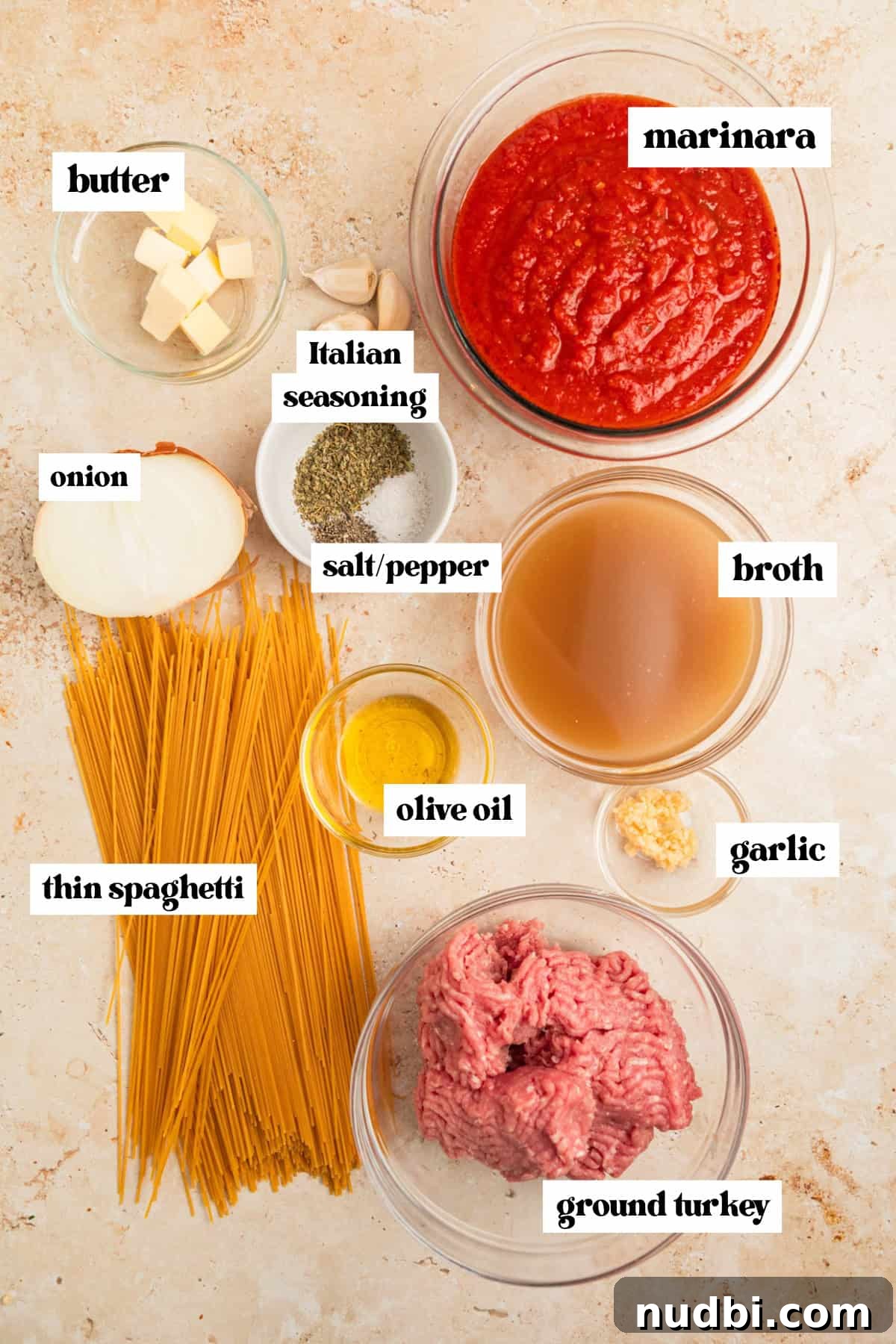 One-Pot Instant Pot Spaghetti Recipe for Quick Weeknight Dinners 4 Marinara, pasta, ground turkey and other ingredients arranged on surface.