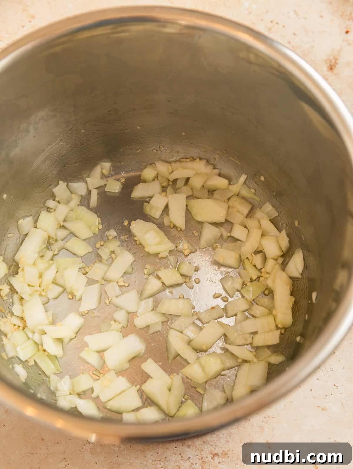One-Pot Instant Pot Spaghetti Recipe for Quick Weeknight Dinners 5 Instant pot with onions being sautéed.
