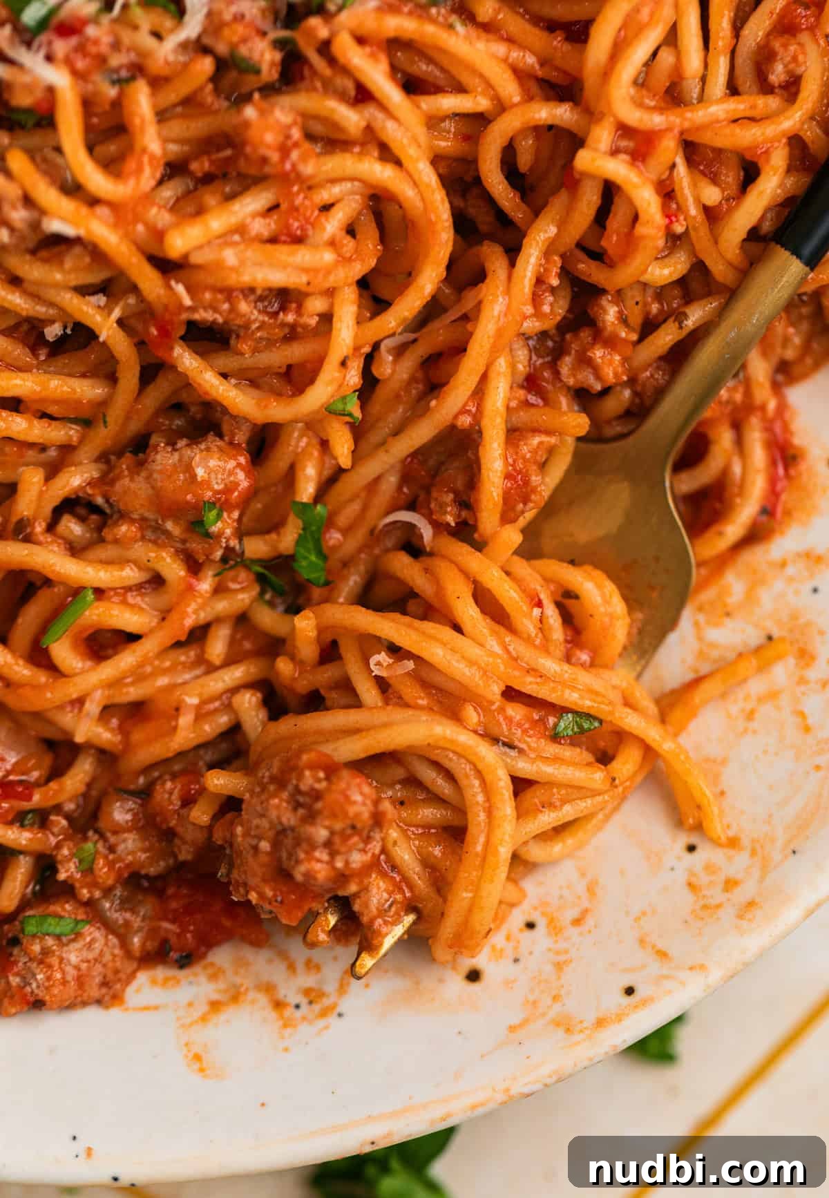 One-Pot Instant Pot Spaghetti Recipe for Quick Weeknight Dinners 10 Forkful of pasta and meat sauce on plate.