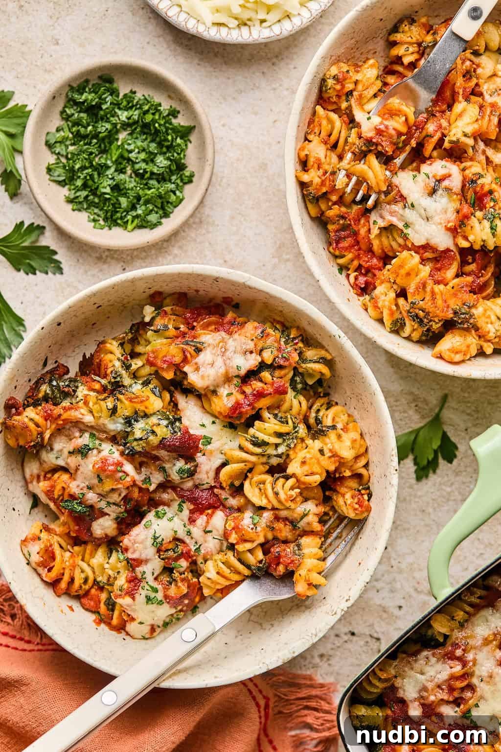 Spinach Baked Pasta with Creamy Cheese and Garlic 3 Bowls with baked cottage cheese and spinach pasta with fresh herbs and cheese melted on top.