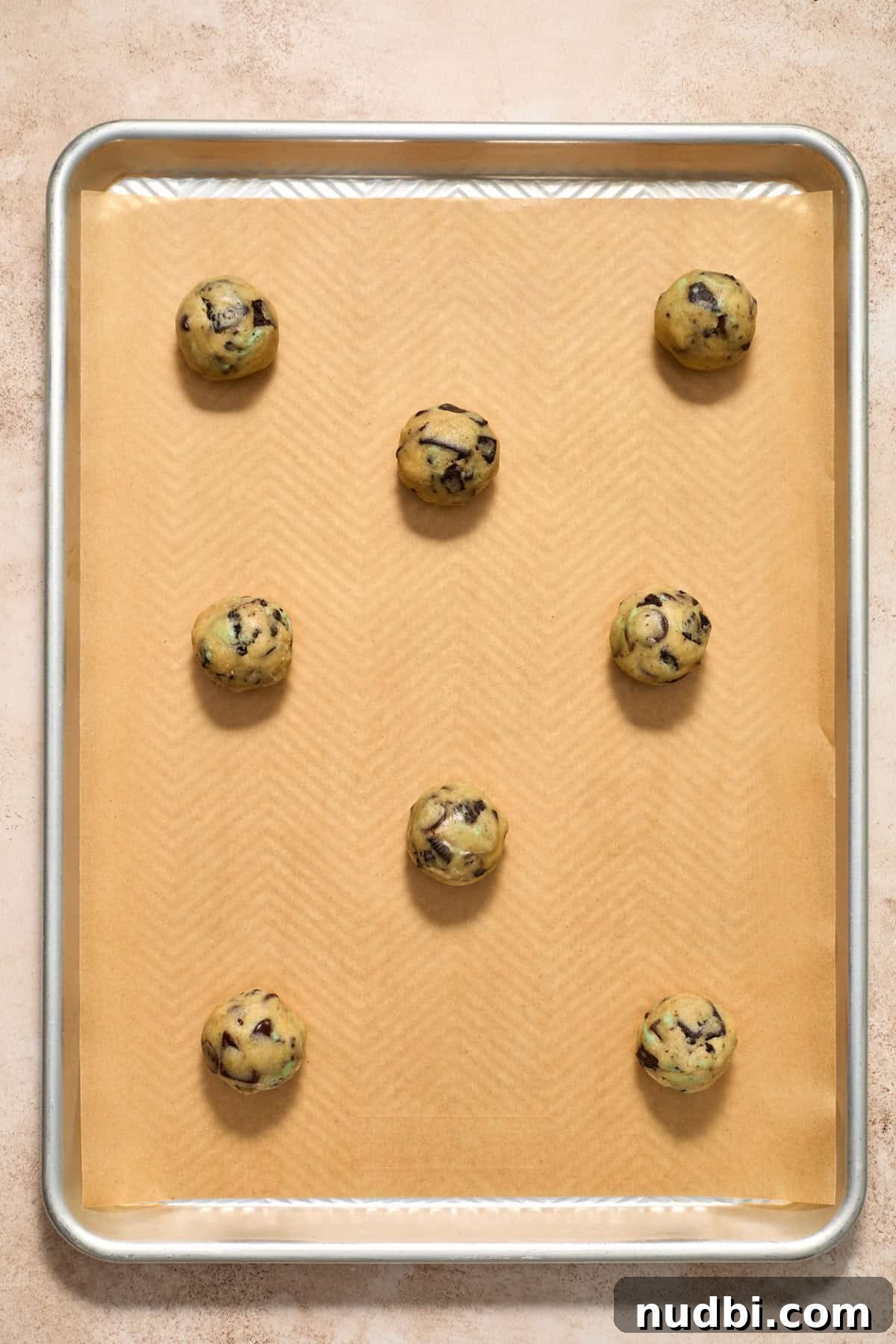 Chewy Mint Chocolate Chip Cookies Recipe for Perfect Cookies 12 Cookie dough balls arranged on parchment lined cookie pan.