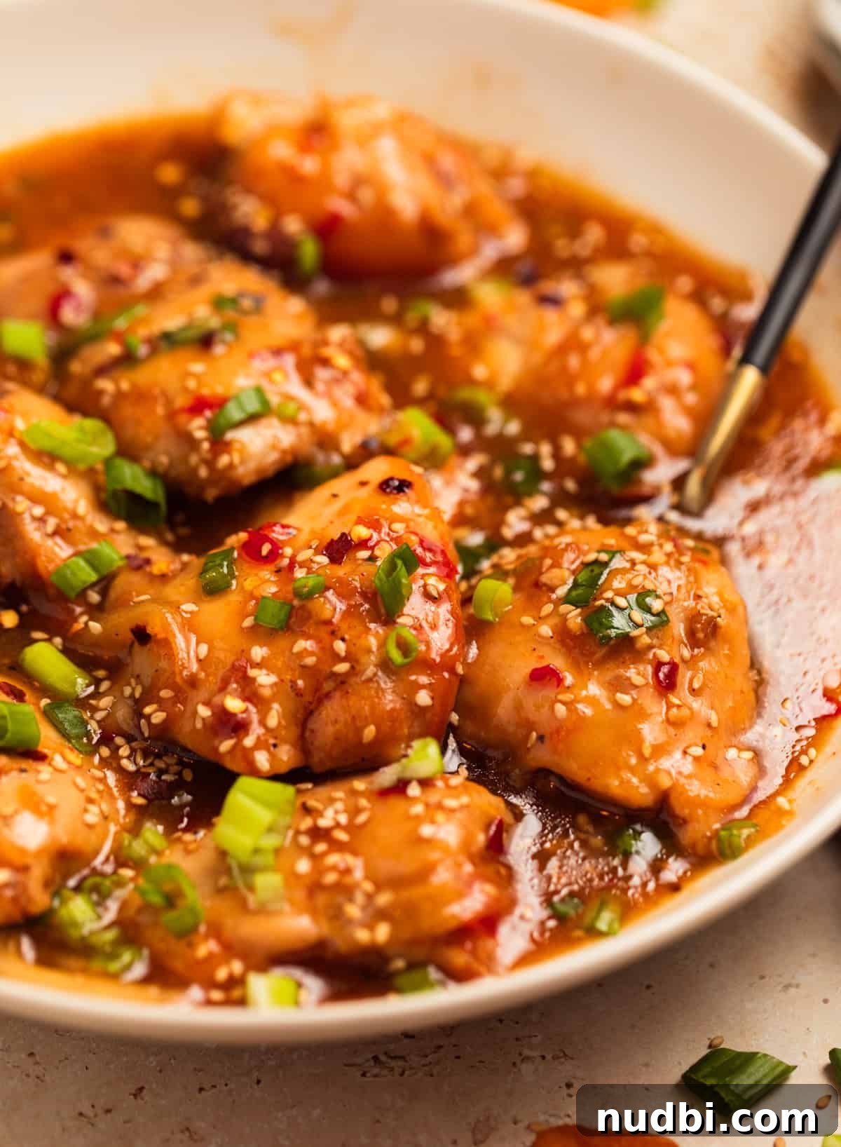 Slow Cooker Apricot-Glazed Chicken Recipe 2 Bowl with slow cooker apricot chicken served with chopped green onions on top.