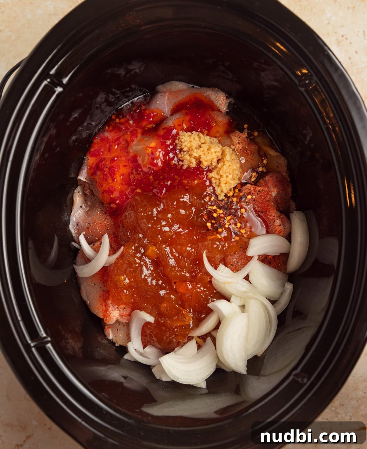 Slow Cooker Apricot-Glazed Chicken Recipe 5 Slow cooker with apricot preserves, onion and seasoning over chicken.