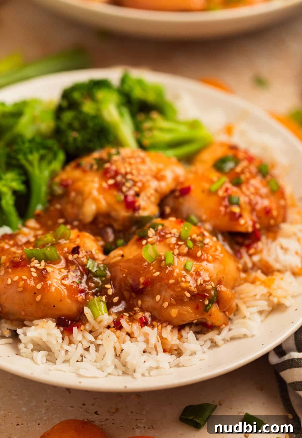 Slow Cooker Apricot-Glazed Chicken Recipe 10 Plate with crockpot apricot chicken over rice and served with broccoli.