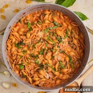 Creamy tomato and turkey pasta in pot.