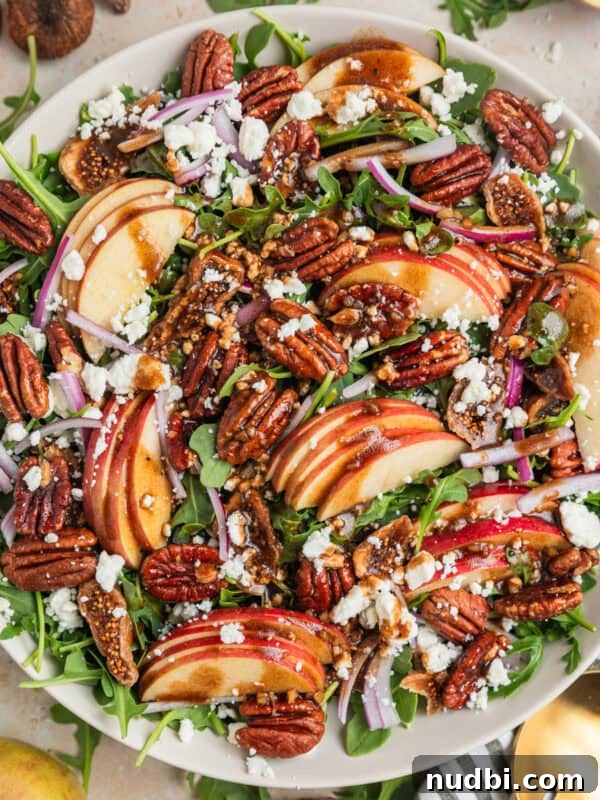 Roasted Sweet Potato and Kale Salad with Maple Dijon Dressing 13 Apple and arugula salad in bowl with toasted maple pecans, goat cheese, dried figs and balsamic dressing.