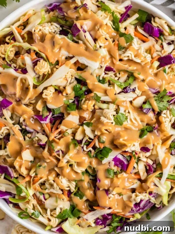 Roasted Sweet Potato and Kale Salad with Maple Dijon Dressing 14 Ramen cabbage salad with peanut dressing over top in white bowl.