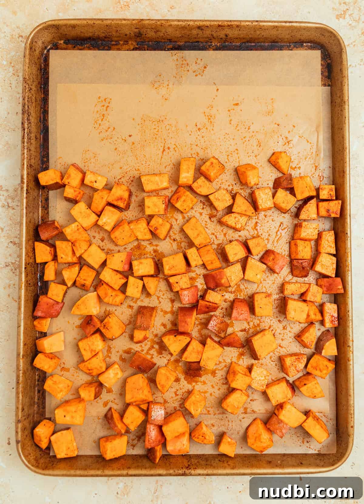 Roasted Sweet Potato and Kale Salad with Maple Dijon Dressing 5 Sweet potatoes on baking sheet with parchment paper.