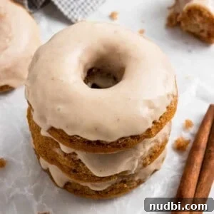 Apple donuts with apple cider glaze stacked.