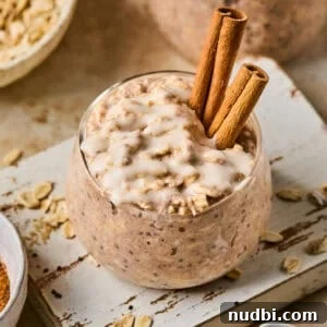 Overnight oats with cinnamon roll flavor in jar with icing drizzled over top.