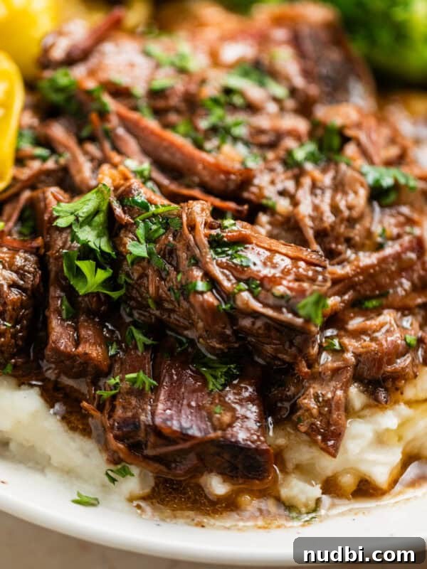 Slow Cooker Cheeseburger Soup Recipe for Weeknight Dinners 14 Mississippi pot roast beef over top of mashed potatoes with parsley over top.