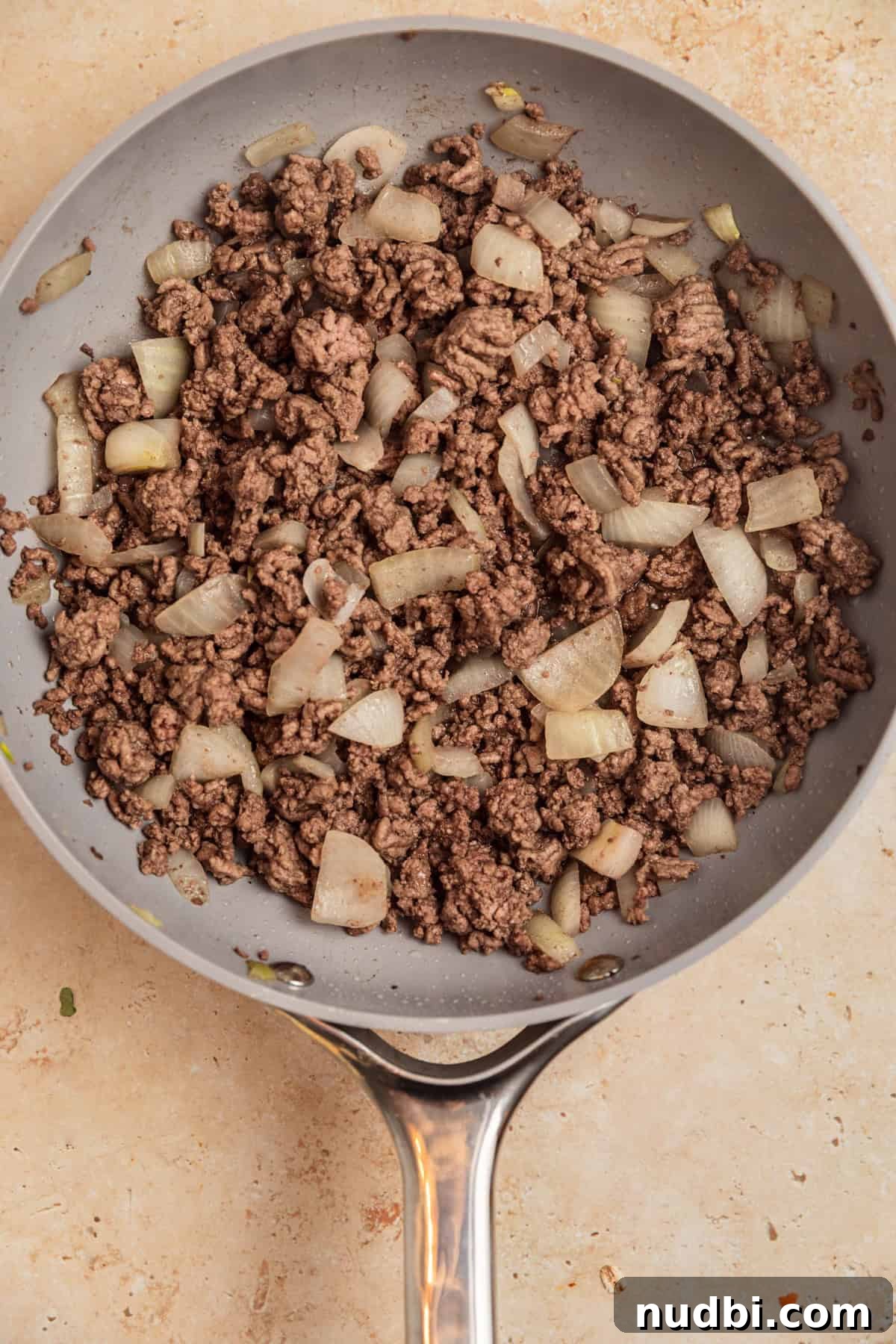 Slow Cooker Cheeseburger Soup Recipe for Weeknight Dinners 5 Ground beef and onions browned in skillet.