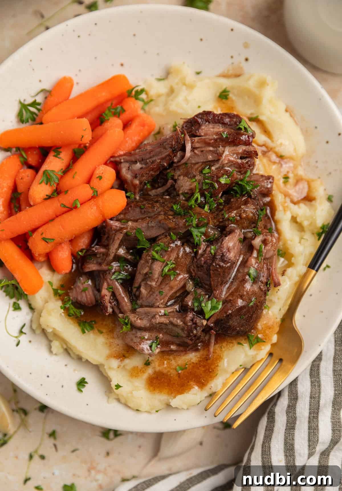 Slow-Cooker Red Wine Braised Short Ribs for Dinner 11 Red wine short ribs with gravy served over mashed potatoes on plate.