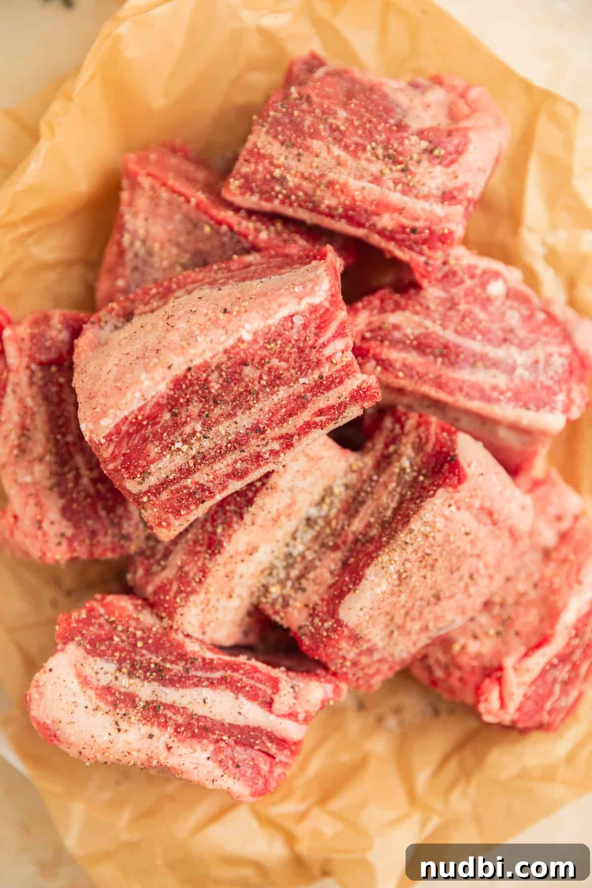 Slow-Cooker Red Wine Braised Short Ribs for Dinner 5 Seasoned short ribs in parchment before searing.