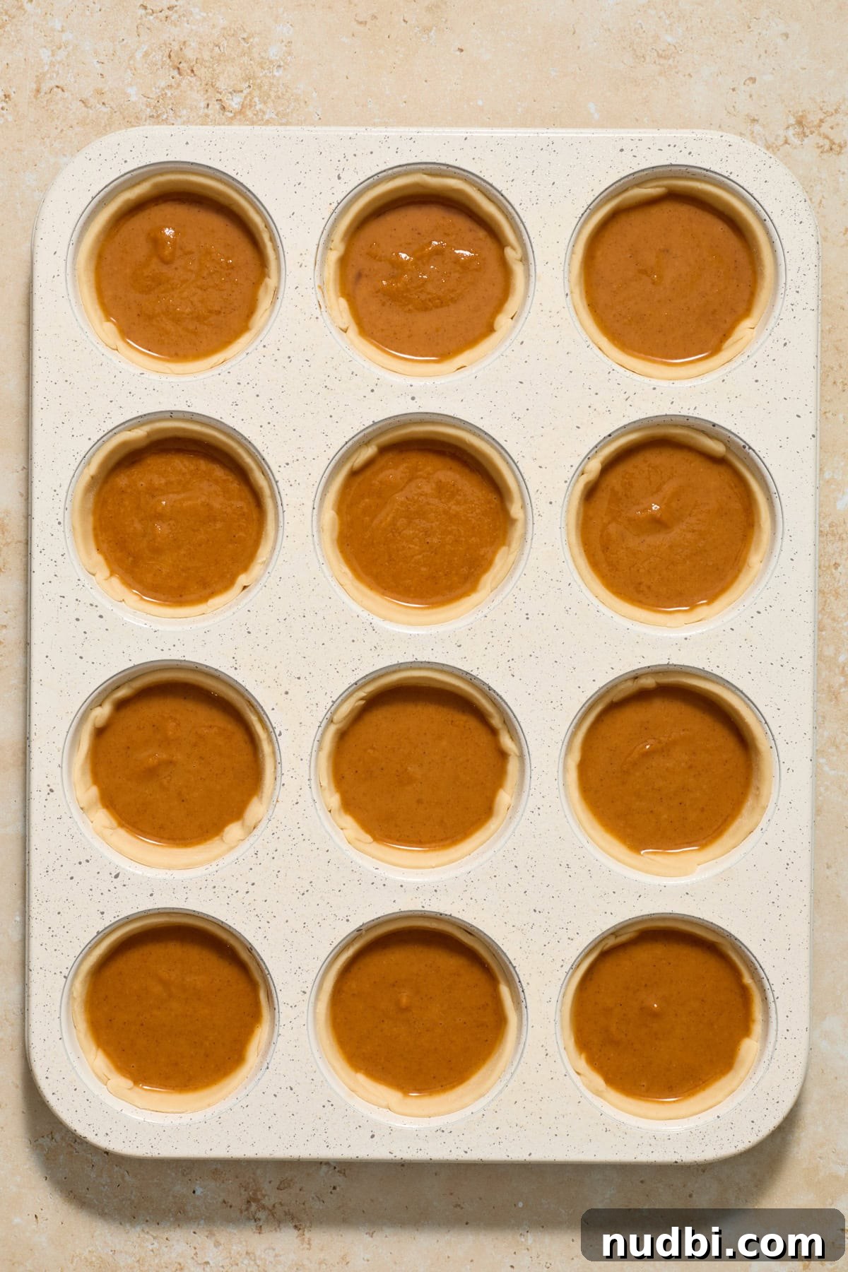 Mini Pumpkin Pies Recipe: Perfect Individual Pumpkin Tarts 9 Muffin tin with mini pumpkin pies before baking.