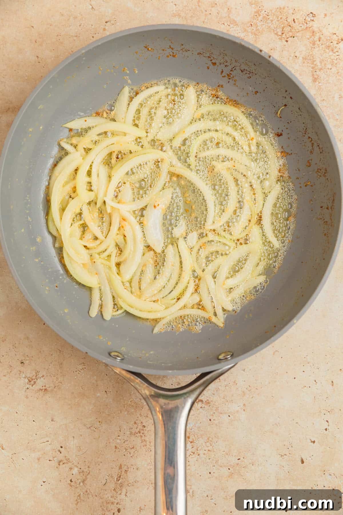 Creamy Gruyère Scalloped Potatoes with Garlic and Thyme 7 Softened onions and butter with garlic in skillet.