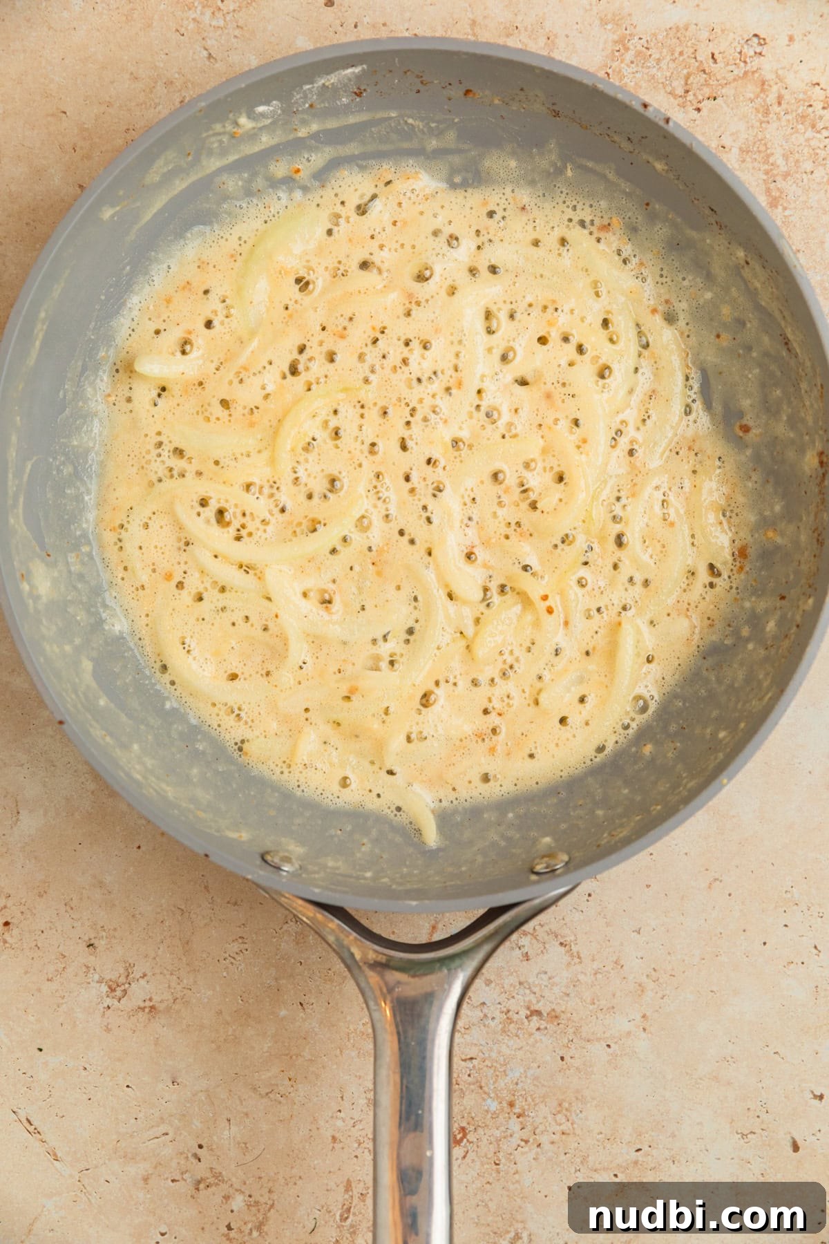 Creamy Gruyère Scalloped Potatoes with Garlic and Thyme 8 Roux prepped in skillet with onions.