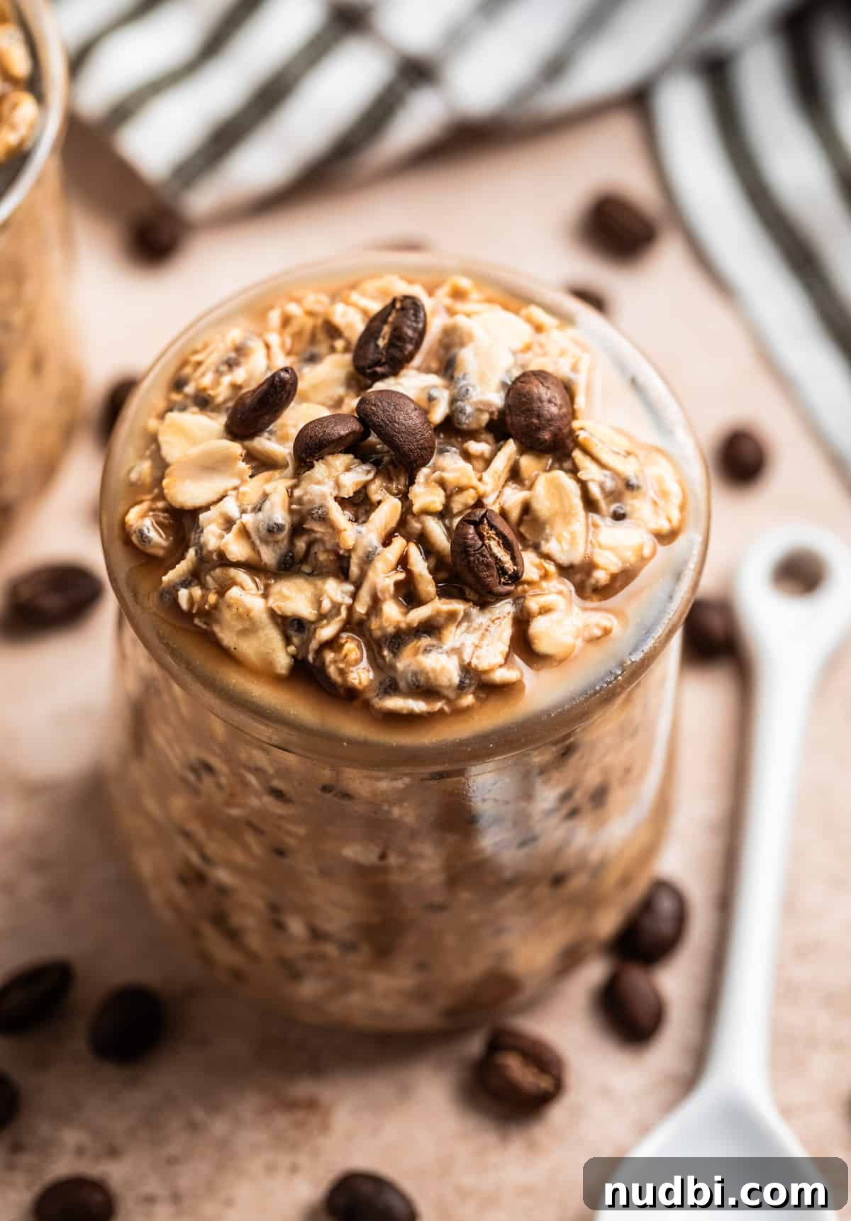 Vanilla Cold Brew Overnight Oats Recipe for Creamy Morning Energy 2 Overnight oatmeal in jar with coffee beans on top.