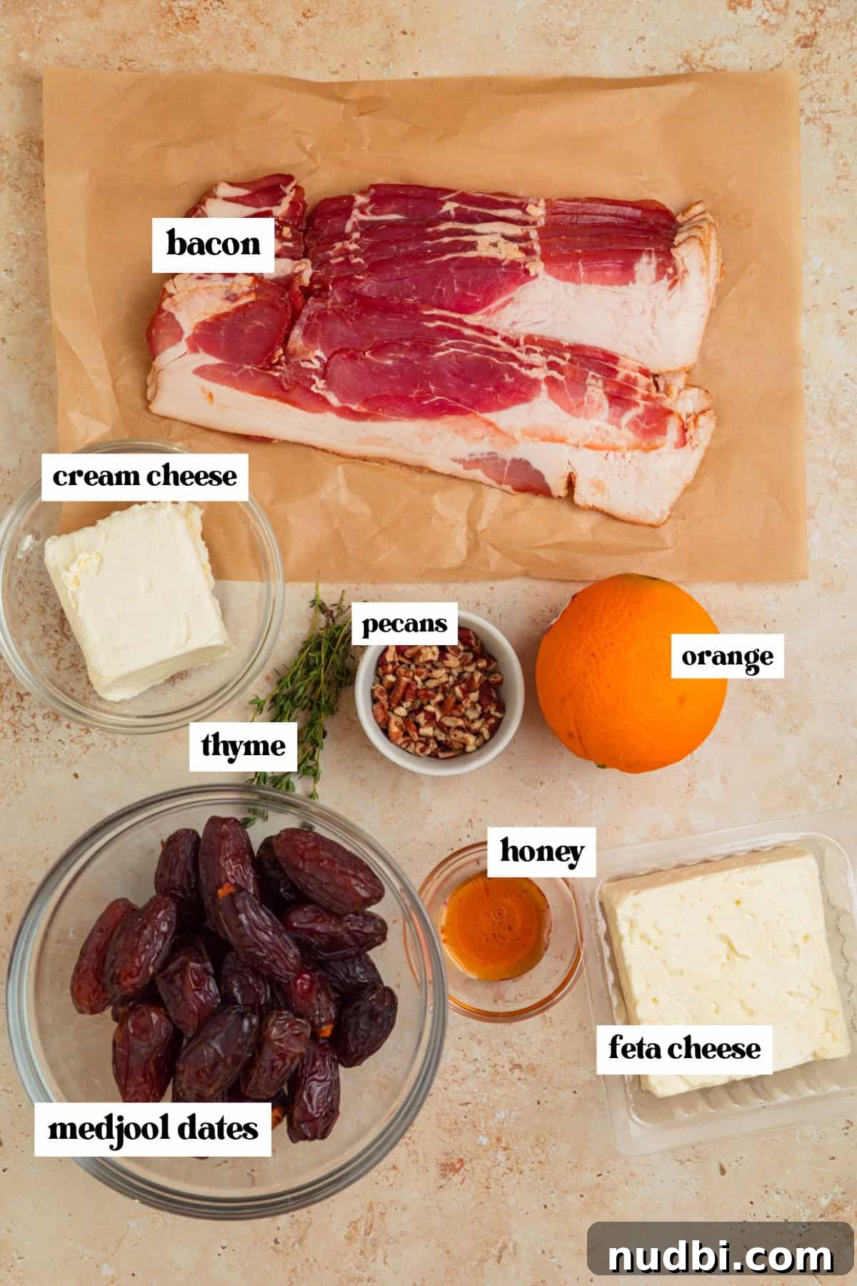 Bacon-Wrapped Dates Stuffed with Goat Cheese and Almonds 4 Bacon, dates, feta and other ingredients labeled on surface.