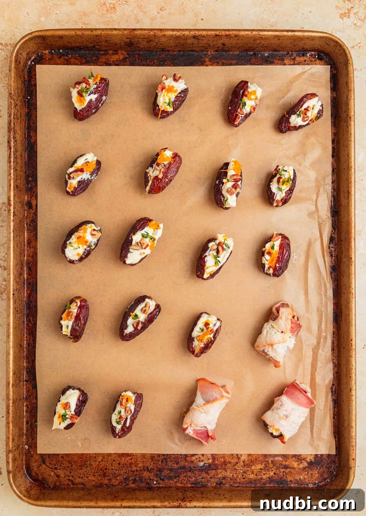 Bacon-Wrapped Dates Stuffed with Goat Cheese and Almonds 8 Dates on parchment stuffed with feta, some wrapped in bacon.