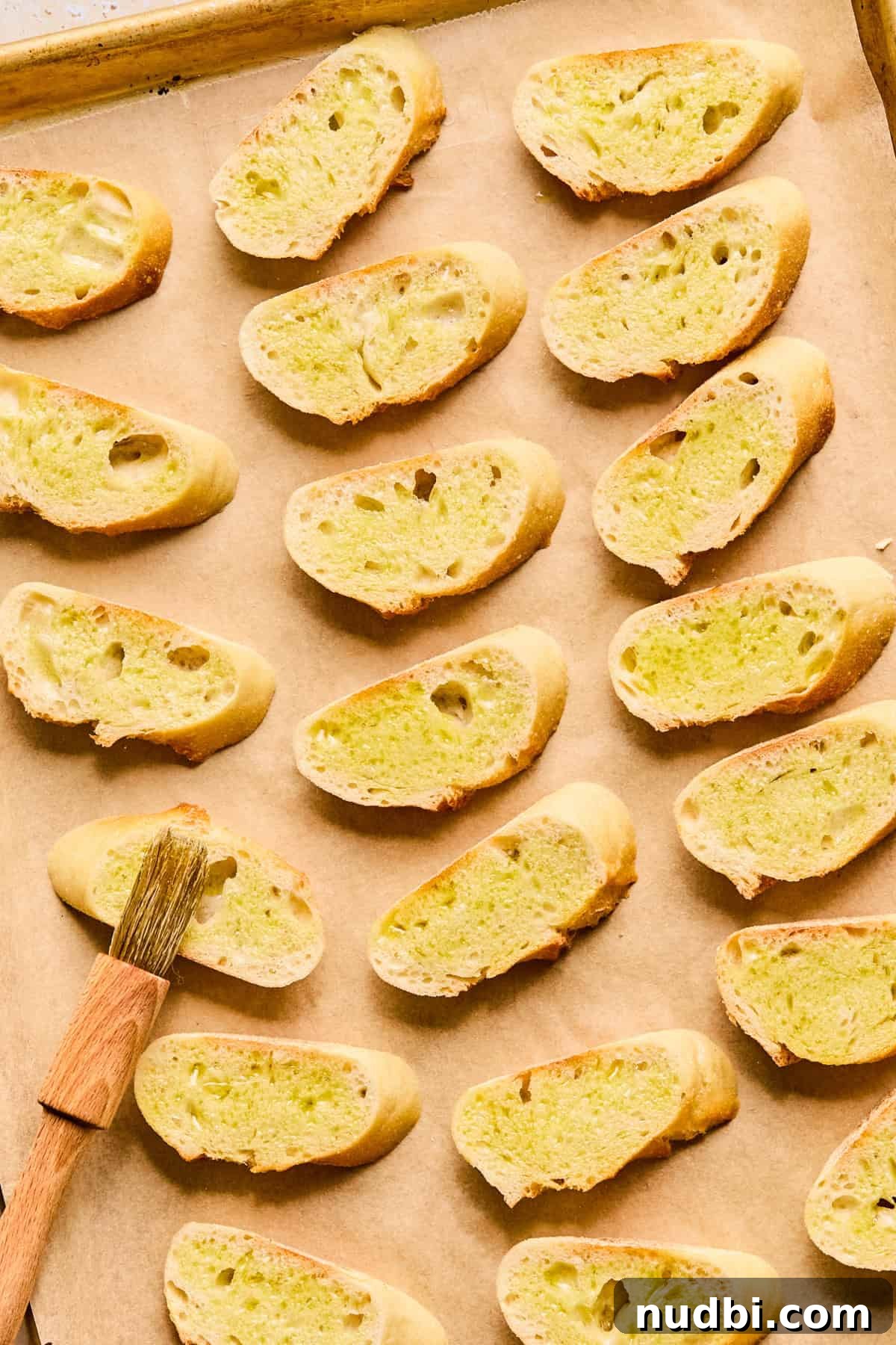 Creamy Whipped Ricotta Dip Recipe for Entertaining 7 Sliced baguette on parchment lined pan with olive oil brushed over top.
