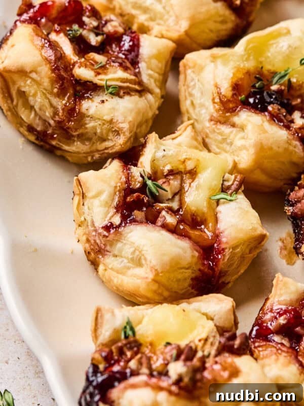 Crispy Goat Cheese Puff Pastry Tart Recipe 13 Puff pastry brie bites on serving platter.