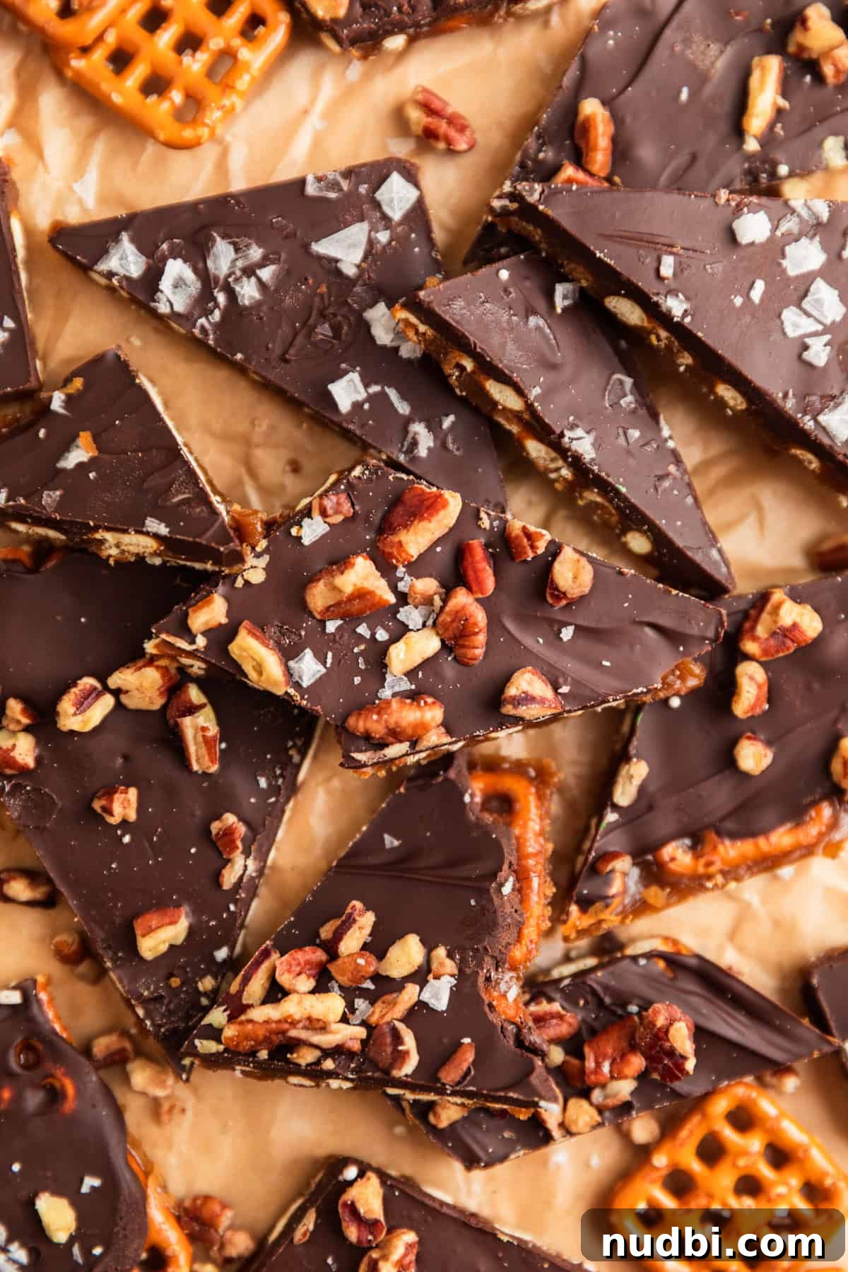 Salted Pretzel Toffee Crunch: Sweet and Salty Candy Recipe 2 Pretzel toffee pieces with chopped pecans and sea salt over top.
