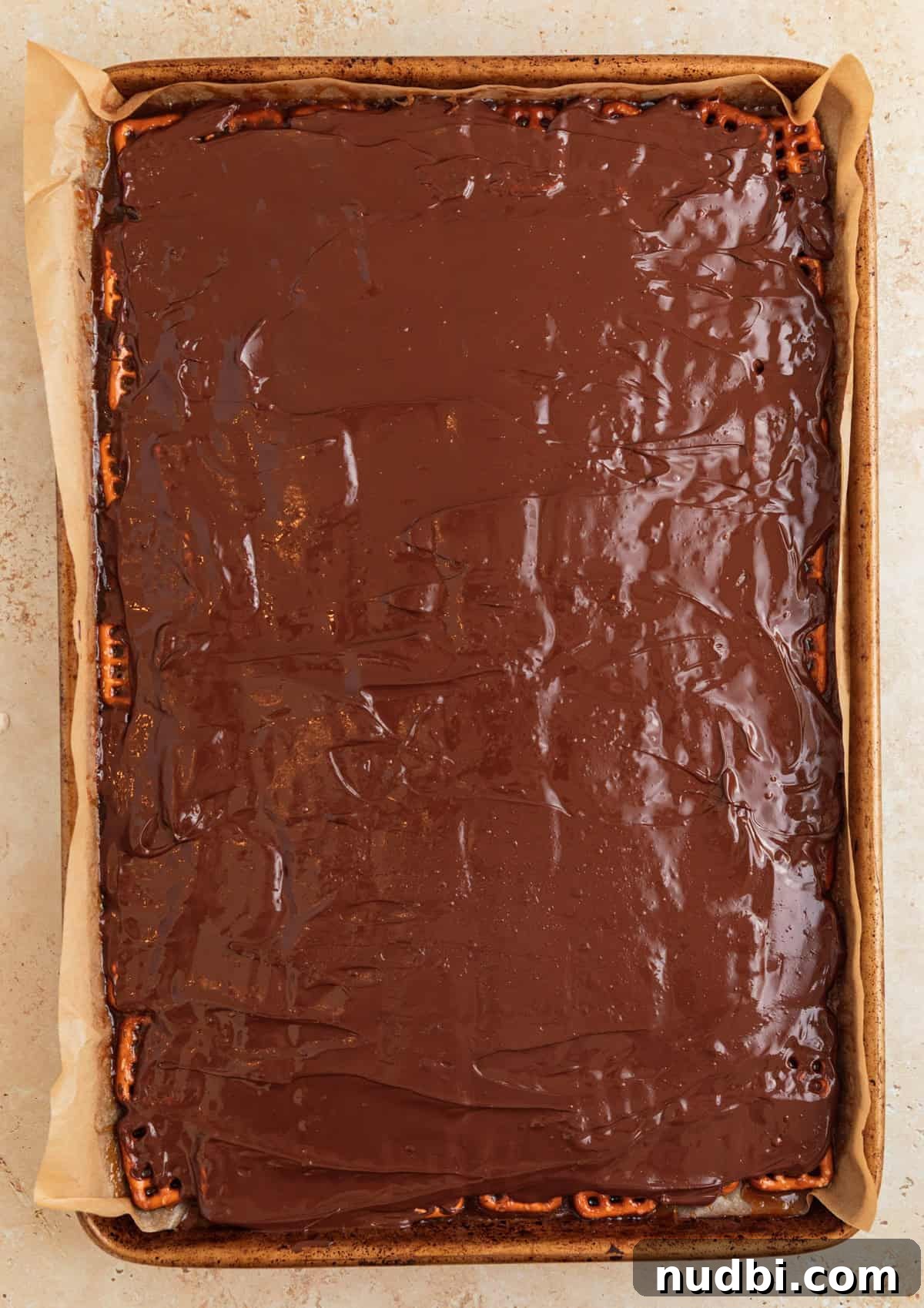 Salted Pretzel Toffee Crunch: Sweet and Salty Candy Recipe 11 Melted chocolate chips spread over top of pretzel toffee.