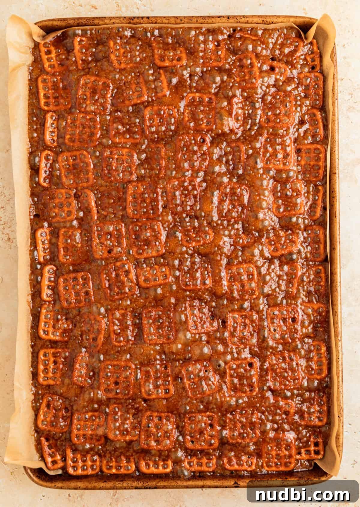 Salted Pretzel Toffee Crunch: Sweet and Salty Candy Recipe 9 Bubbling caramel on top of lined pretzels.