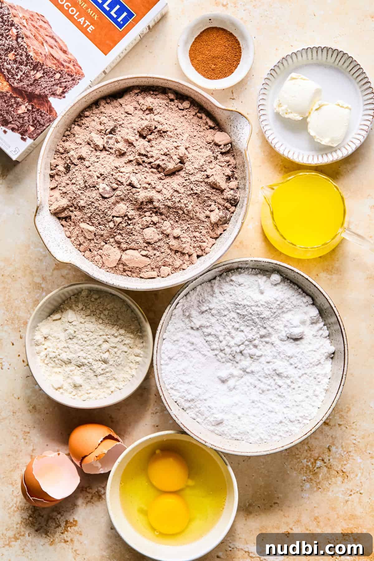 Brownie Crinkle Cookies Recipe — Fudgy, Chewy Chocolate Treats 4 Brownie mix, powdered sugar, eggs and other ingredients arranged on surface.