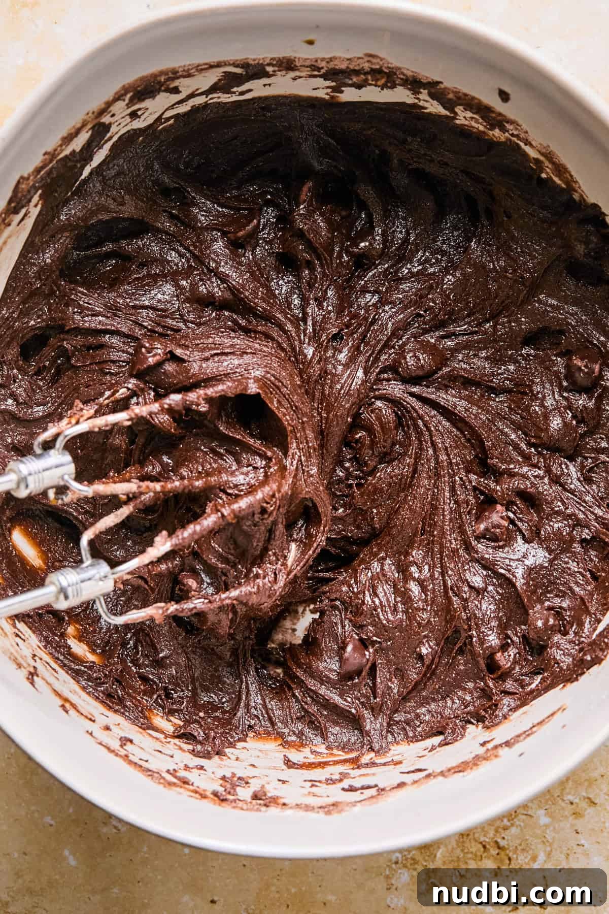 Brownie Crinkle Cookies Recipe — Fudgy, Chewy Chocolate Treats 6 Beaten brownie cookie dough in bowl with mixer.