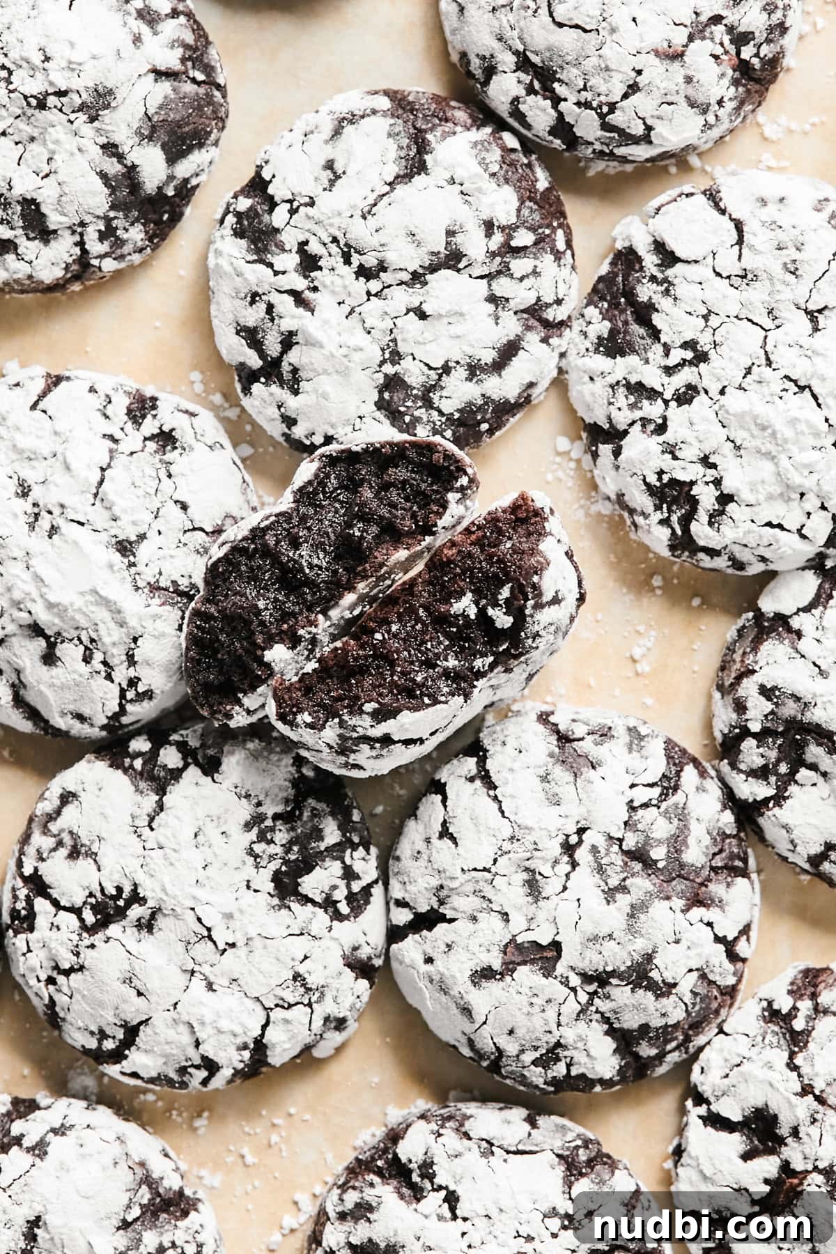Brownie Crinkle Cookies Recipe — Fudgy, Chewy Chocolate Treats 9 Chocolate crinkle cookies on surface.