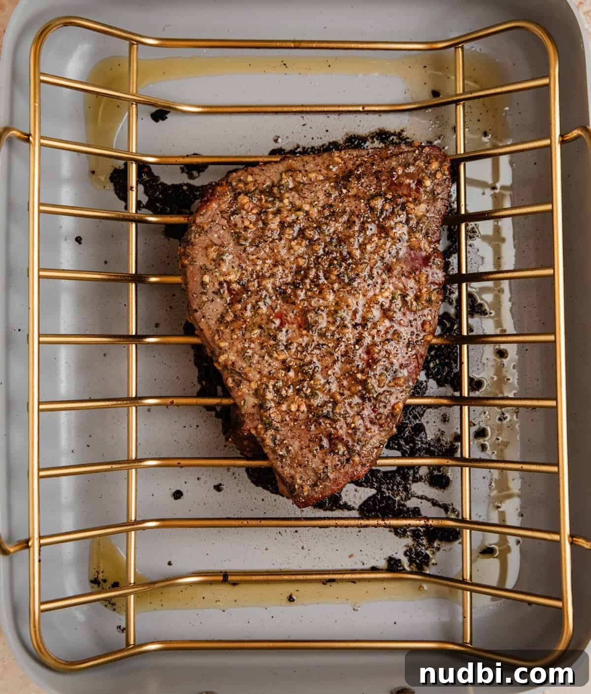 Juicy Top Round Roast Beef Recipe for Tender Slices 8 Cooked top round roast beef in roasting pan.