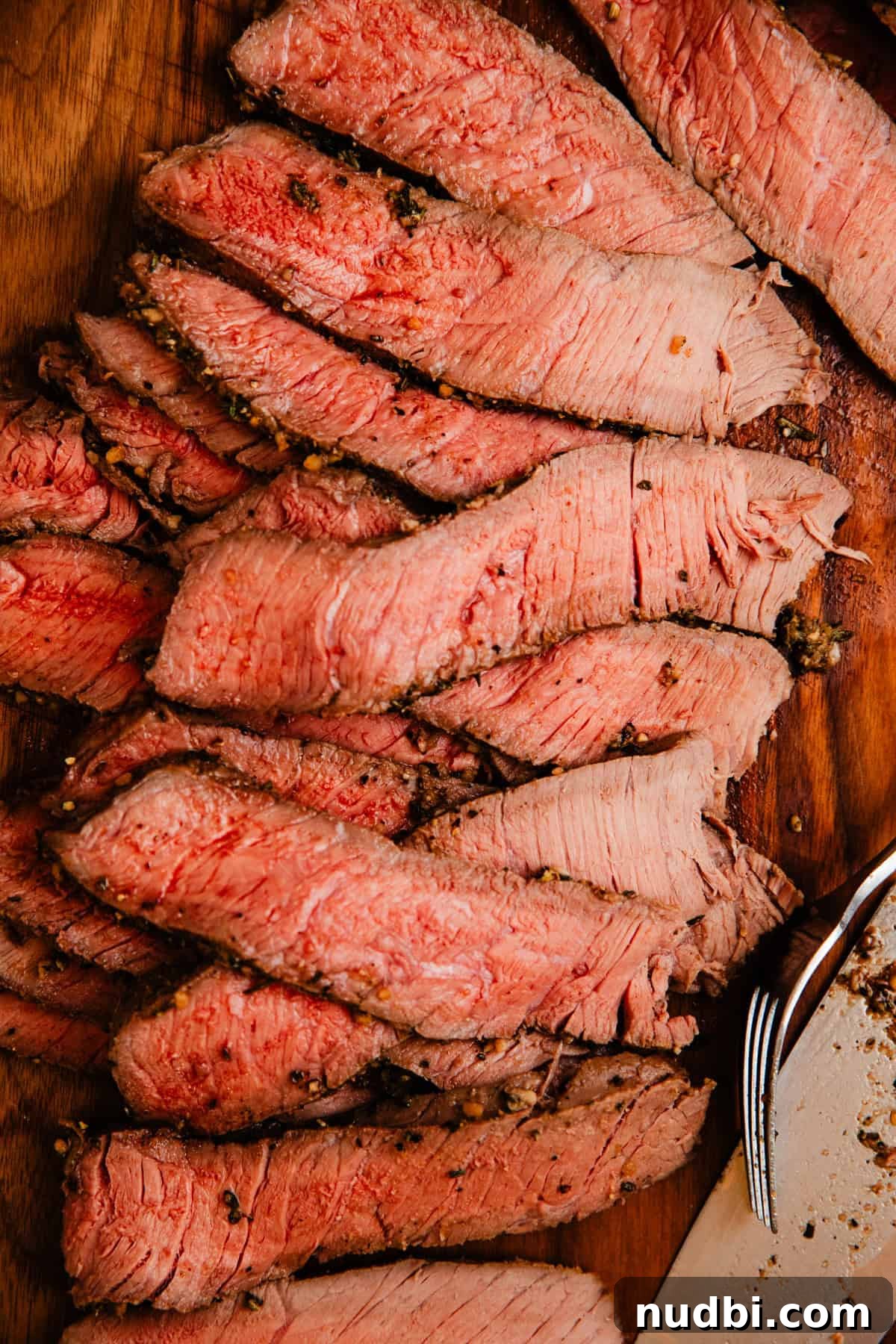 Juicy Top Round Roast Beef Recipe for Tender Slices 9 Sliced roast beef on cutting board.