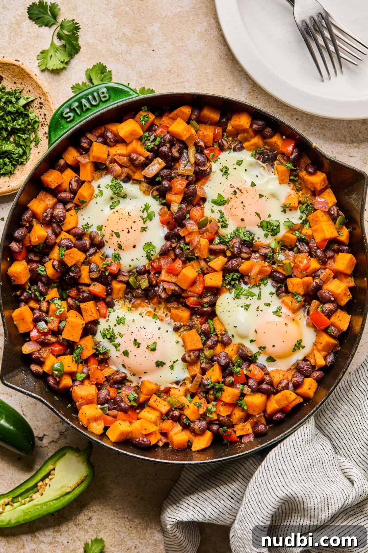 Savory Sweet Potato Breakfast Hash with Crispy Veggies 2 Sweet potato black bean breakfast hash in skillet with cilantro garnish over top.