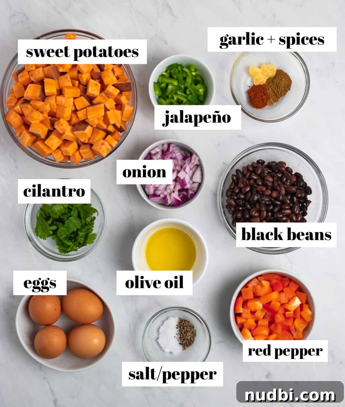 Savory Sweet Potato Breakfast Hash with Crispy Veggies 3 Beans, peppers, eggs, spices and other ingredients labeled on counter.