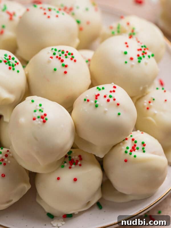 Ritz Cracker Cookies Stuffed with Reese's Cups 12 Plate with white chocolate covered Christmas Oreo cookie truffles topped with red, white and green sprinkles.