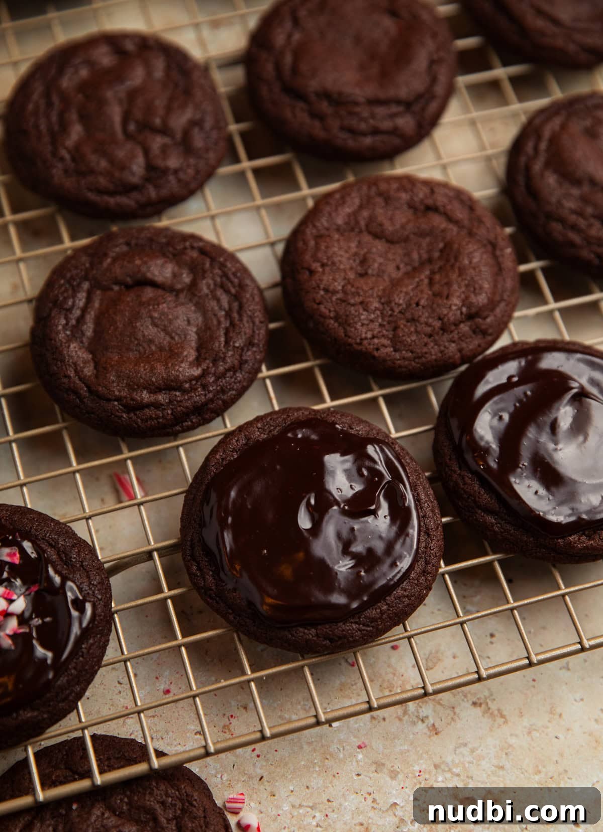 Peppermint Mocha Cookie Recipe — Chocolate Coffee Holiday Cookies 14 Ganache spread on chocolate peppermint mocha cookies on cooling rack.
