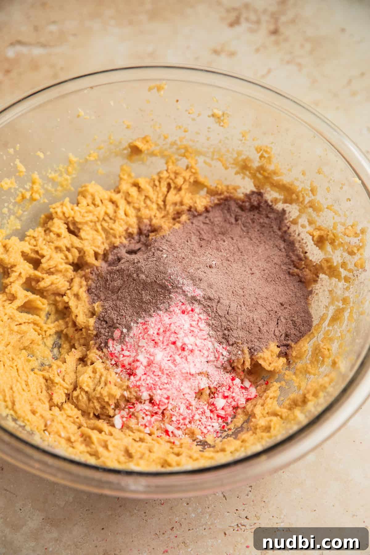 Peppermint Mocha Cookie Recipe — Chocolate Coffee Holiday Cookies 8 Dry ingredients and crushed candy canes added to bowl with wet ingredients.