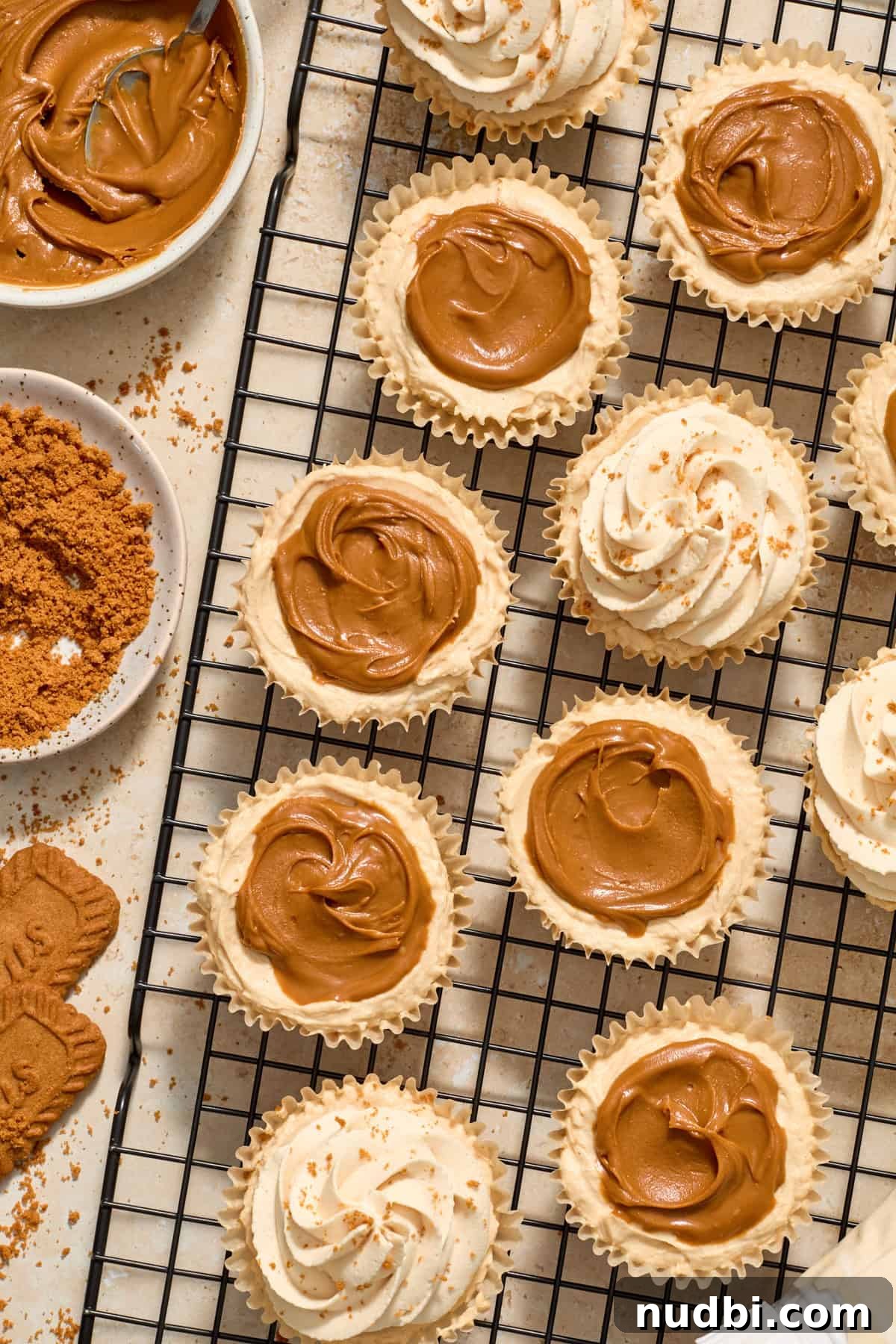 No-Bake Mini Biscoff Cheesecakes Recipe for Crowd-Pleasing Treats 14 Piped whipped cream on top of mini biscoff cheesecakes.
