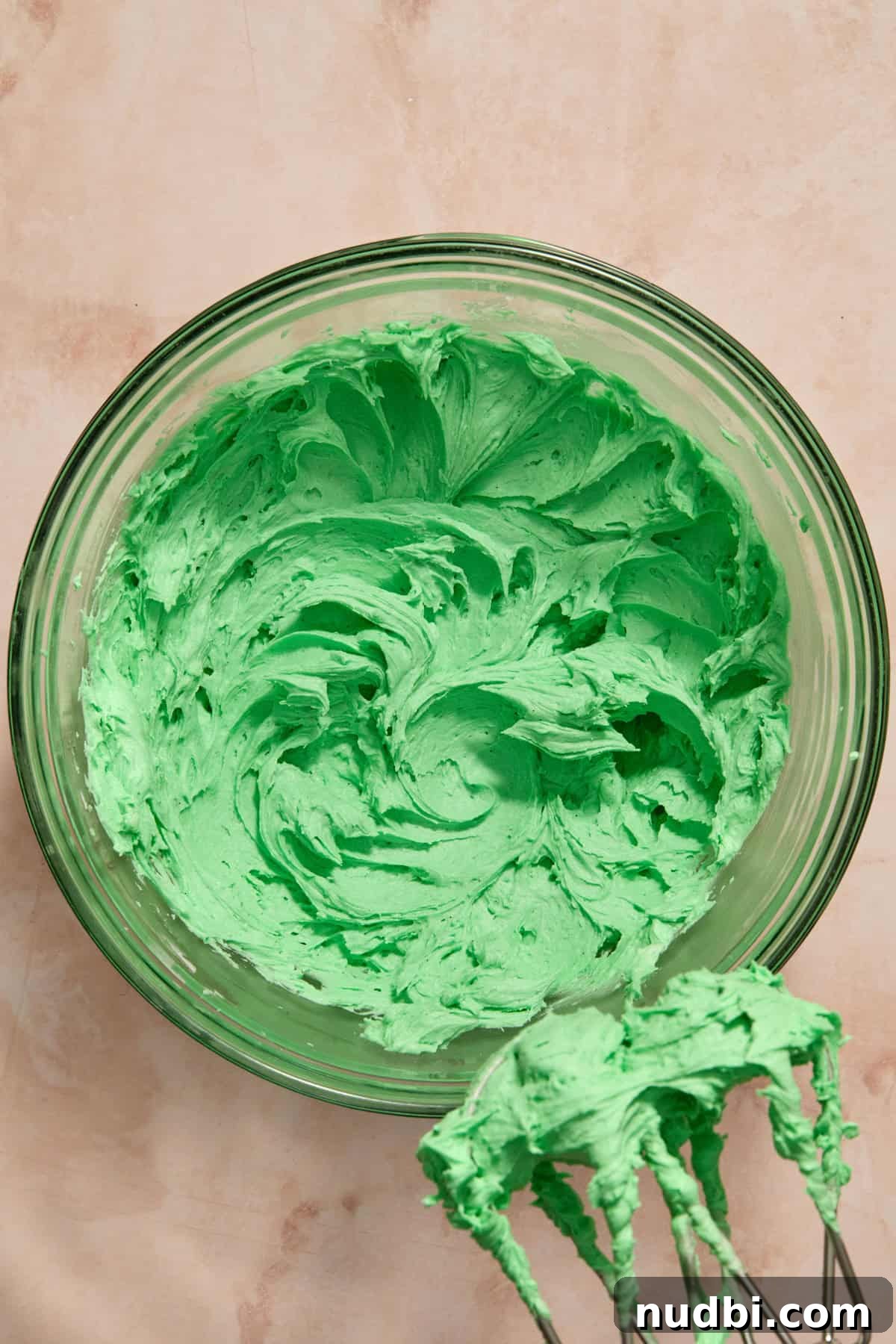 Christmas Sugar Cookie Bars Recipe with Festive Frosting 12 Green buttercream in mixing bowl.