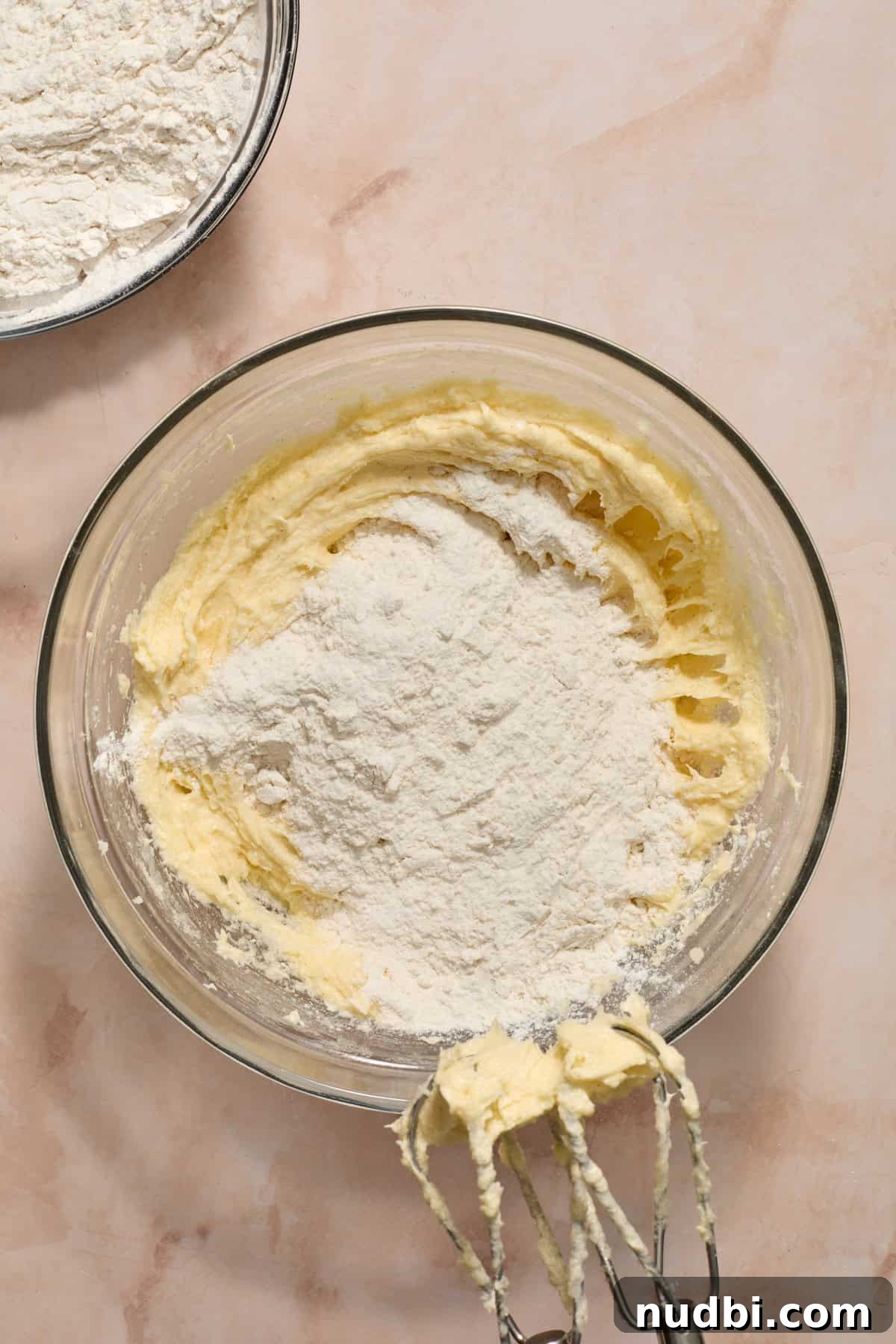 Christmas Sugar Cookie Bars Recipe with Festive Frosting 7 Dry ingredients added to wet ingredients in mixing bowl.